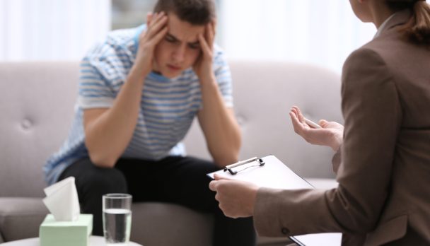 Psychotherapist,Working,With,Young,Man,In,Office