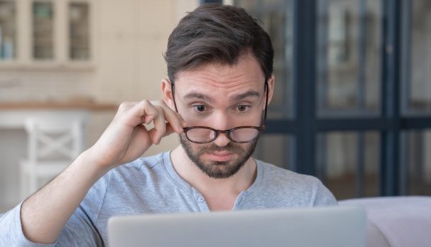 Surprised,Shocked,With,The,Bad,News,,Information,On,Laptop,Middle-aged